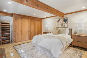 Bedroom with beam ceiling and ornamental molding