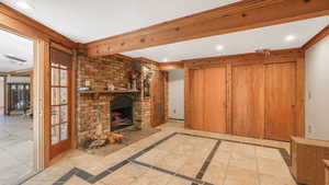 Bedroom with ornamental molding and a brick fireplace