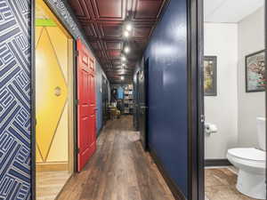 Corridor with dark hardwood / wood-style flooring