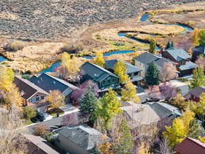 Birds eye view of property with a water view