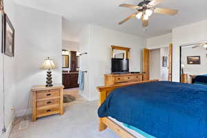 Carpeted bedroom with ceiling fan