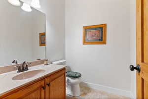 Bathroom with vanity, toilet, and tile patterned floors