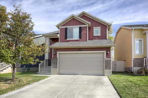 View of front of home featuring a garage and a front lawn