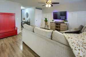 Living room with laminate  wood-style floors and ceiling fan