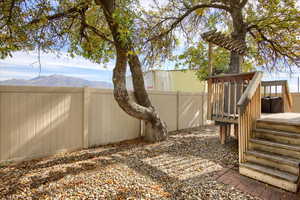 View of yard featuring a deck with mountain view