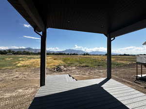 Deck with a rural view and a mountain view