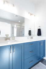 Bathroom with vanity, hardwood / wood-style floors, and a shower with shower door