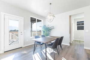 Dining space featuring a chandelier and light wood-type flooring