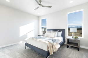 Bedroom featuring ceiling fan, carpet, and multiple windows