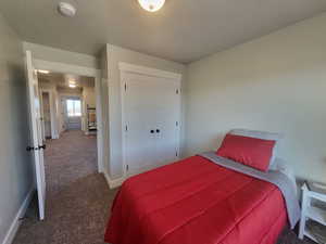 Bedroom featuring a closet and dark carpet