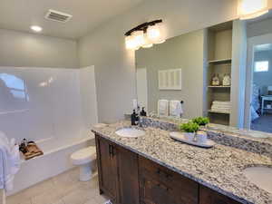 Full bathroom featuring toilet, shower / washtub combination, vanity, and tile patterned floors