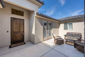 Property entrance with a patio area