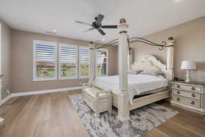 Bedroom with ceiling fan and light wood-type flooring