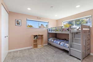 Carpeted bedroom with a closet