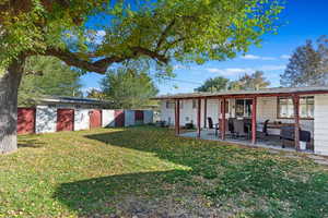 Back of property with a patio area, a lawn, and central AC unit