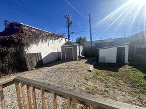 View of backyard with a storage shed