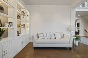 Living area featuring dark wood-type flooring