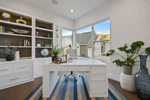 Home office featuring dark hardwood / wood-style flooring