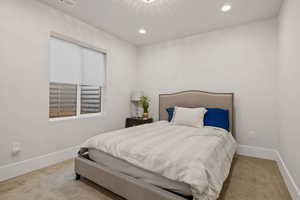 Bedroom with light colored carpet