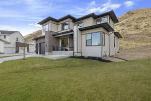 View of front of home featuring a garage and a front lawn