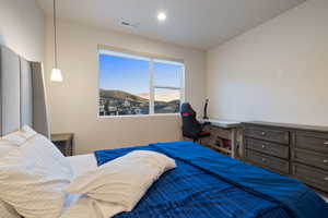 Bedroom featuring vaulted ceiling and a mountain view