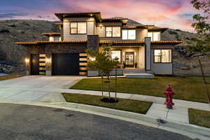 View of front of house with a yard and a garage