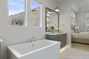 Bathroom with vanity, a mountain view, and a bathing tub