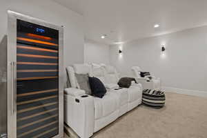 Cinema room with wine cooler and light carpet