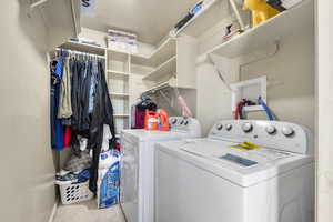 Laundry area featuring carpet and washing machine and clothes dryer