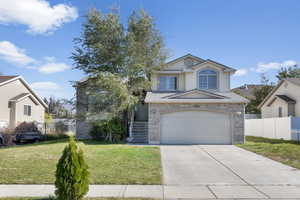 Front of property with a front yard and a garage