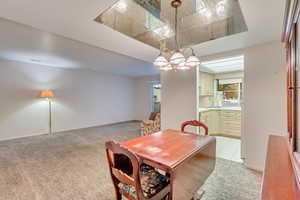 Dining area featuring light colored carpet