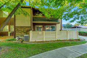 Back of property featuring central AC and a balcony