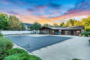 Pool at dusk with a patio