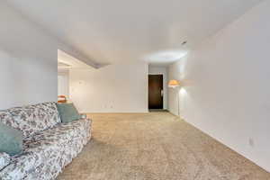 View of family room from the sliding glass door, looking towards the front entrance.