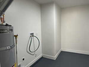 Laundry area featuring hookup for an electric dryer, hookup for a washing machine, and gas water heater