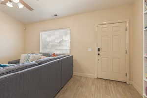 Living room with ceiling fan and new light laminate flooring