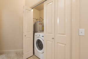 Laundry area with 1 YR OLD washer / clothes dryer and water heater