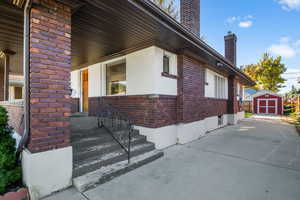 View of home's exterior with a storage unit