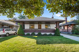 View of front facade with a porch and a front lawn