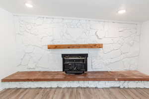 Details with a wood stove and wood-type flooring