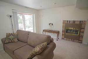 Living room with carpet flooring and a fireplace