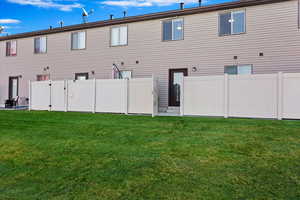 Rear view of property featuring a yard