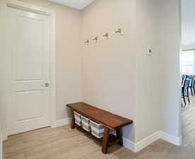 Located between the garage and great room, with a half bath on the right and laundry on left.