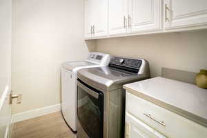 Spaciously laundry with both upper and lower cabinets.