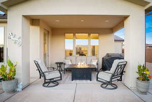 Protected covered patio with outdoor lighting and rough-in for future fan.