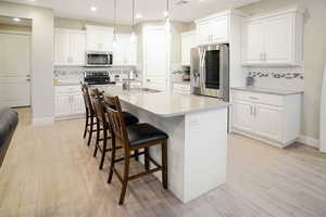 Staggered cabinets in Pure White, with soft close drawers and doors. Stainless steel appliances, including a double oven. (Fridge excluded but negotiable)