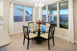 Dining area has upgraded chandelier, and curtains - for a more elegant feel.