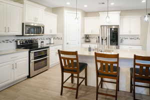 Ash gray quartz counters throughout. Upgraded backsplash.