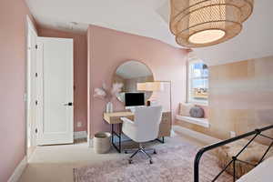 Office featuring light colored carpet and vaulted ceiling