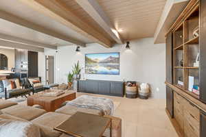 Tiled living room featuring beam ceiling and wood ceiling